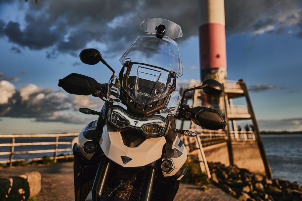 white and black motorcycle on brown ground during daytime