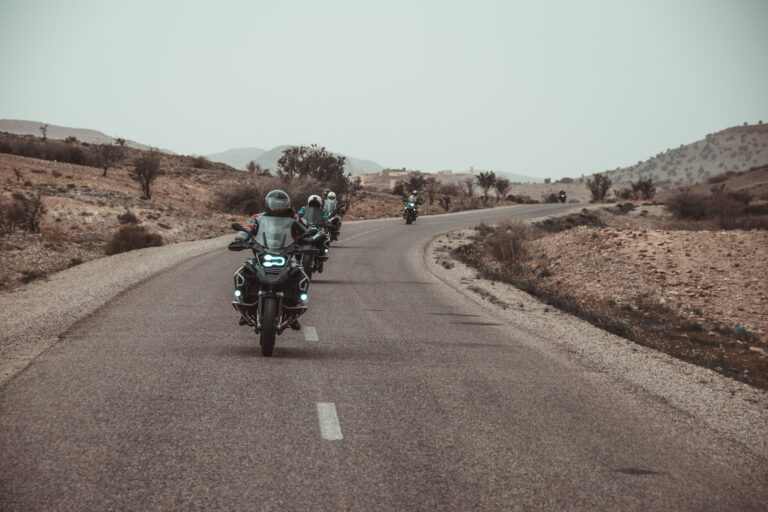 riders riding motorbike on asphalt road