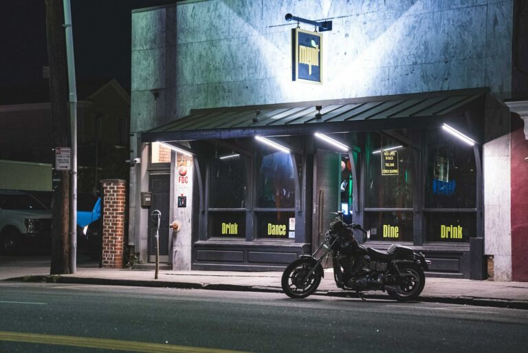 a motorcycle parked in front of a building at night